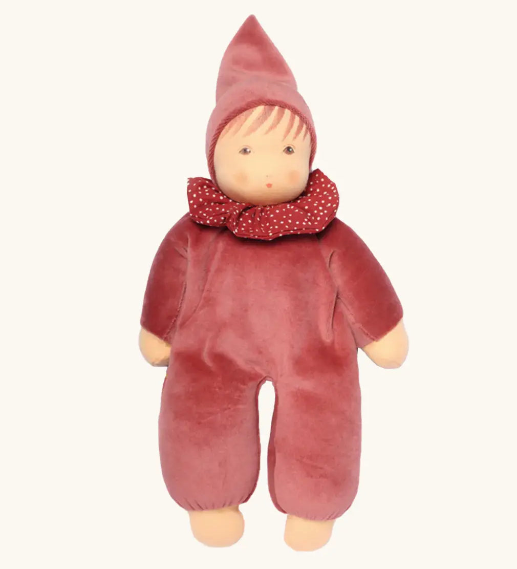Nanchen nani soft doll in cedar pink with a waldorf style face. Showing a red with white spots frilled scarf and red hat