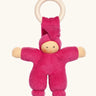 Nanchen Pimpel Doll Baby Comforter in berry pink with a Waldorf-style face and wooden teething ring attached by its hat. 