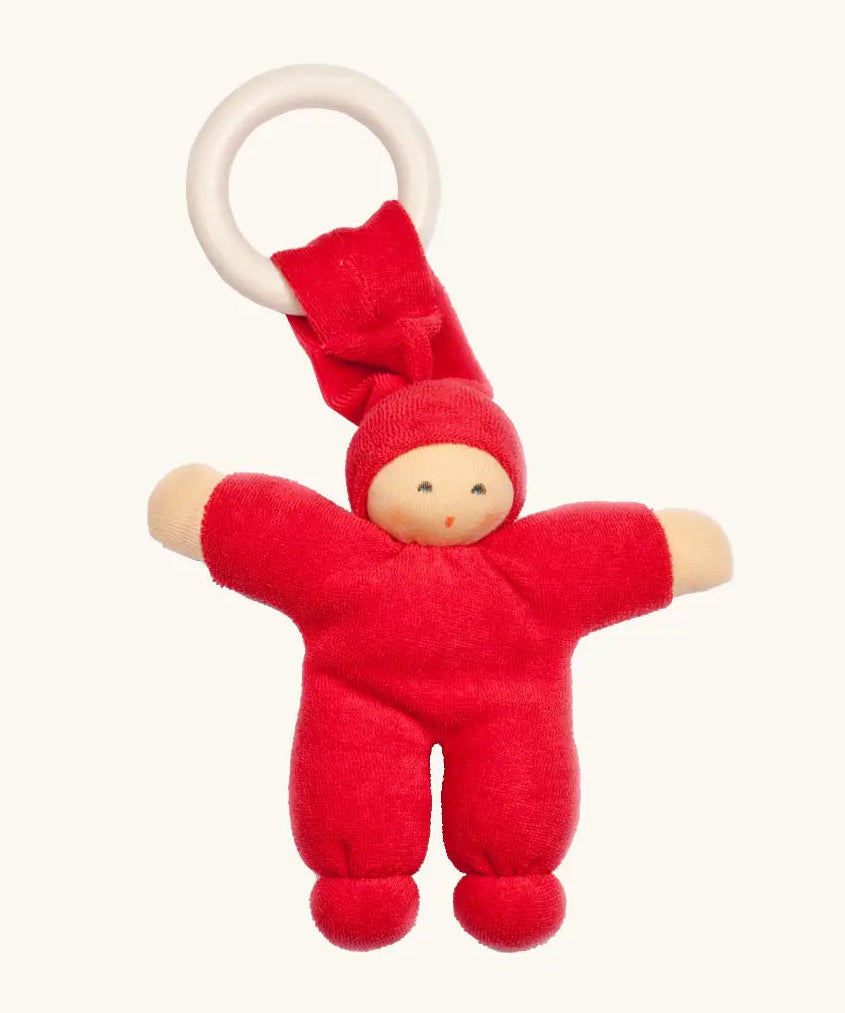 Nanchen Pimpel Doll Baby Comforter in cherry red with a Waldorf-style face and wooden teething ring attached by its hat. 