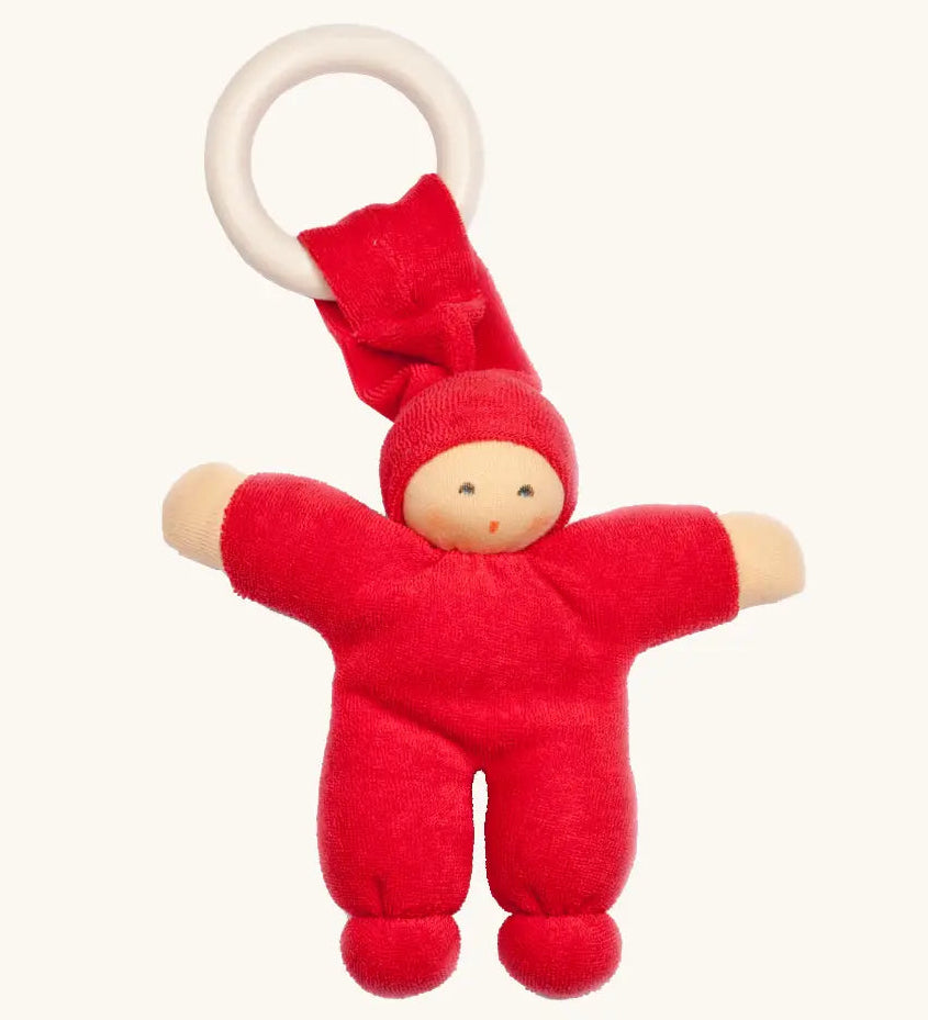 Nanchen Pimpel Doll Baby Comforter in cherry red with a Waldorf-style face and wooden teething ring attached by its hat. 