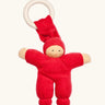 Nanchen Pimpel Doll Baby Comforter in cherry red with a Waldorf-style face and wooden teething ring attached by its hat. 