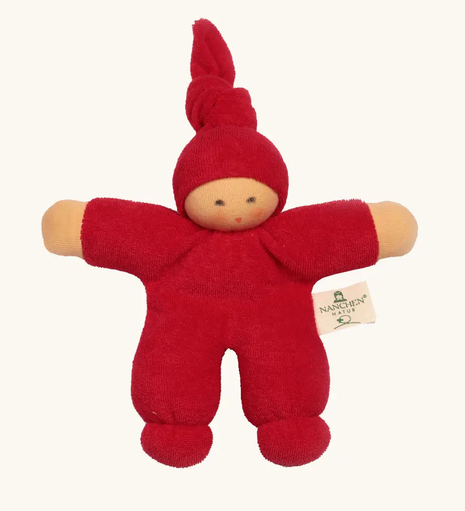Nanchel pimpel waldorf doll in cherry red. Showing cute facial features and a tie on the hat. Doll has a terry cloth body 