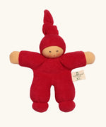 Nanchel pimpel waldorf doll in cherry red. Showing cute facial features and a tie on the hat. Doll has a terry cloth body 