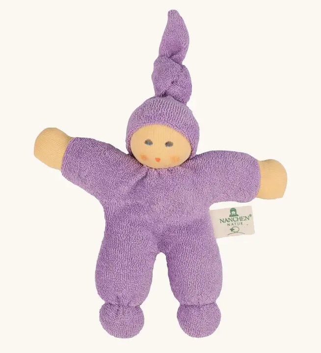 Nanchel pimpel waldorf doll in lilac. Showing cute facial features and a tie on the hat. Doll has a terry cloth body 