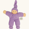 Nanchel pimpel waldorf doll in lilac. Showing cute facial features and a tie on the hat. Doll has a terry cloth body 