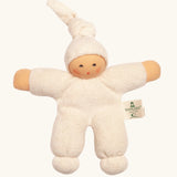 Nanchel pimpel waldorf doll in cream white. Showing cute facial features and a tie on the hat. Doll has a terry cloth body 