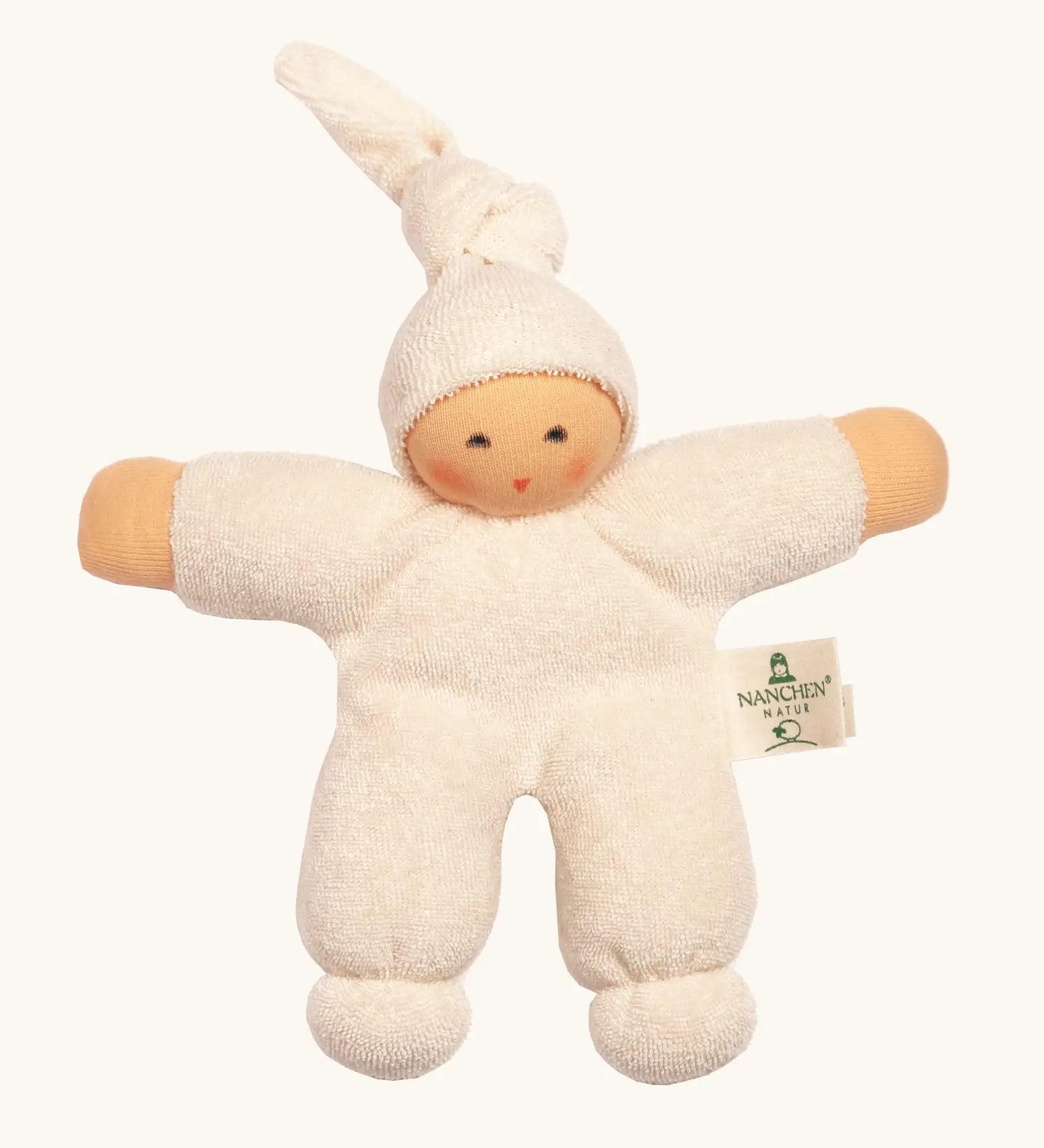 Nanchel pimpel waldorf doll in cream white. Showing cute facial features and a tie on the hat. Doll has a terry cloth body 