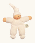 Nanchel pimpel waldorf doll in cream white. Showing cute facial features and a tie on the hat. Doll has a terry cloth body 