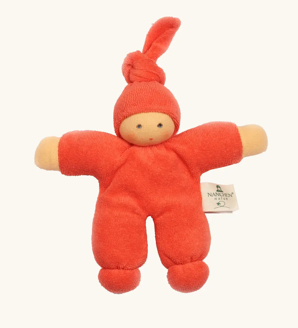 Nanchel pimpel waldorf doll in orange red. Showing cute facial features and a tie on the hat. Doll has a terry cloth body 