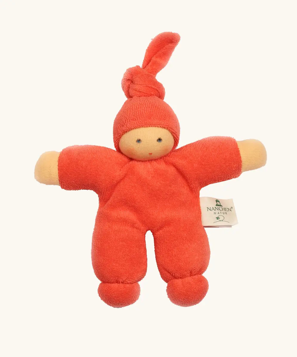 Nanchel pimpel waldorf doll in orange red. Showing cute facial features and a tie on the hat. Doll has a terry cloth body 