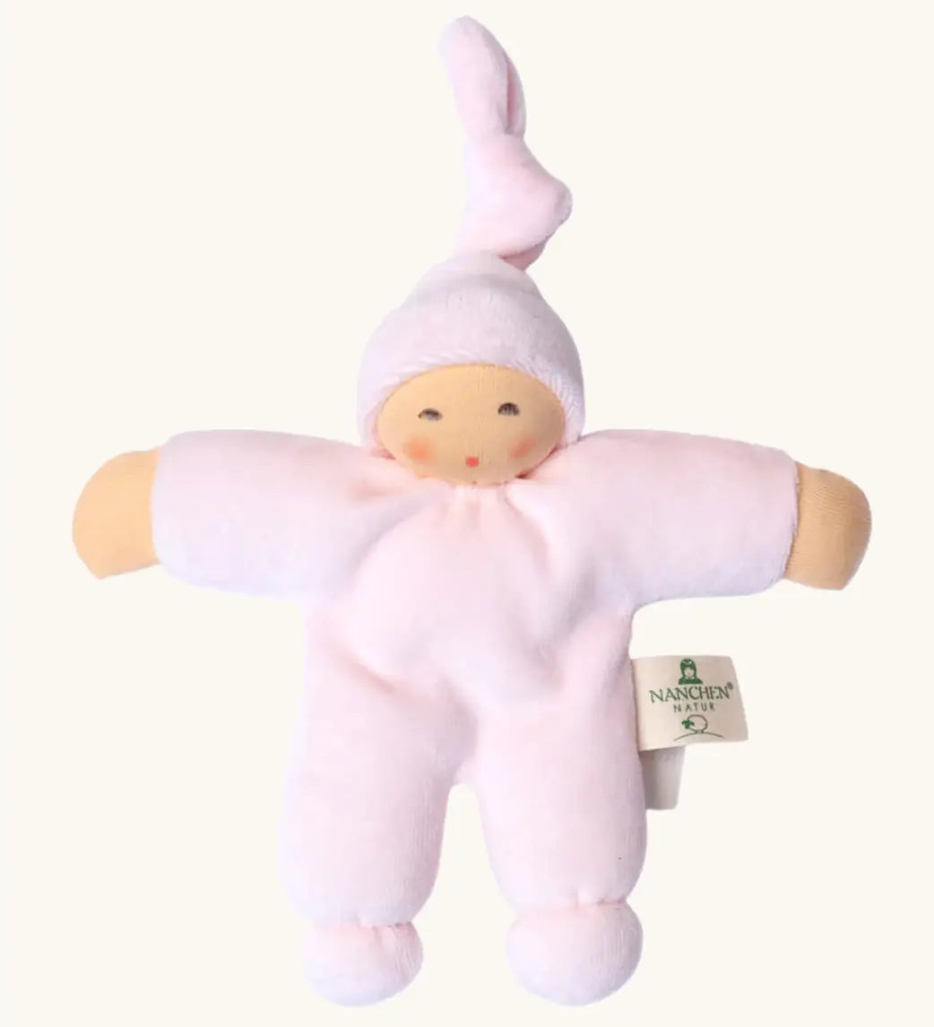 Nanchel pimpel waldorf doll in pastel pink. Showing cute facial features and a tie on the hat. Doll has a terry cloth body 