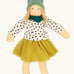 Nanchen Mascha waldorf doll showing a green terry cloth, long sleeve top with black dots, a yellow skirt and a green scarf
