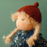 Nanchen winterchild lotta doll showing close up of the Waldorf style face and knitted orange hat