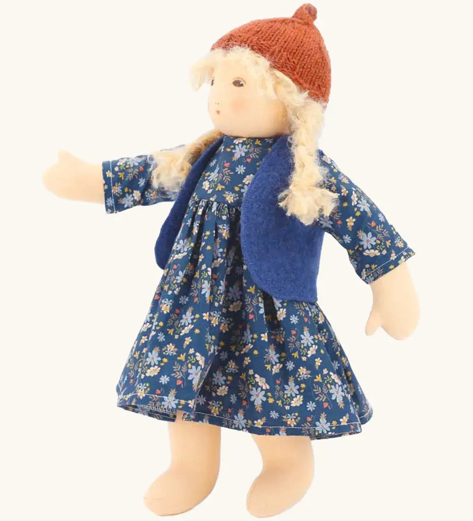Nanchen Lotta winterchild doll with a Waldorf style face, blonde hair. Showing removable blue waistcoat, navy floral dress and orange hat