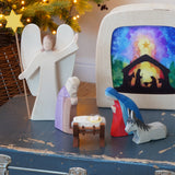 Nativity Christmas scene featuring wooden toy figures from Ostheimer - Donkey II, Angel with Star, Mary, Joseph  and Baby Jesus in Crib II - available to buy at Babipur.
