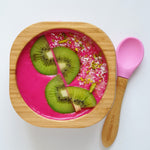 A pink desert with fresh kiwi fruit in the Eco Rascals Bamboo Bowl & Spoon Weaning Set in pink silicone.