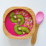 A pink desert with fresh kiwi fruit in the Eco Rascals Bamboo Bowl & Spoon Weaning Set in pink silicone.