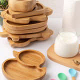 Eco Rascals Duck Bamboo Suction Plate, with a stack of other bamboo plates and bowl in the background. 