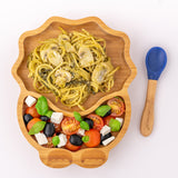 Eco Rascals Dinosaur Bamboo Suction Plate with spaghetti and mushrooms with a Greek salad side, and blue silicone and bamboo baby spoon.