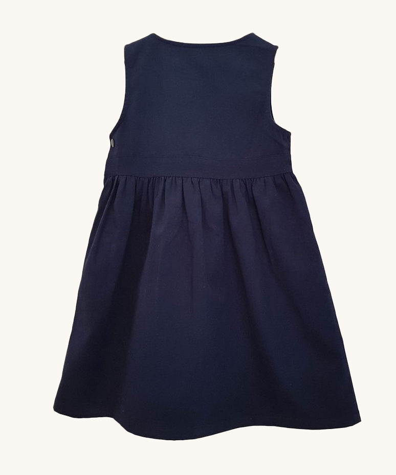 The back of the Eco Outfitters organic and fair trade cotton school pinafore dress in navy.