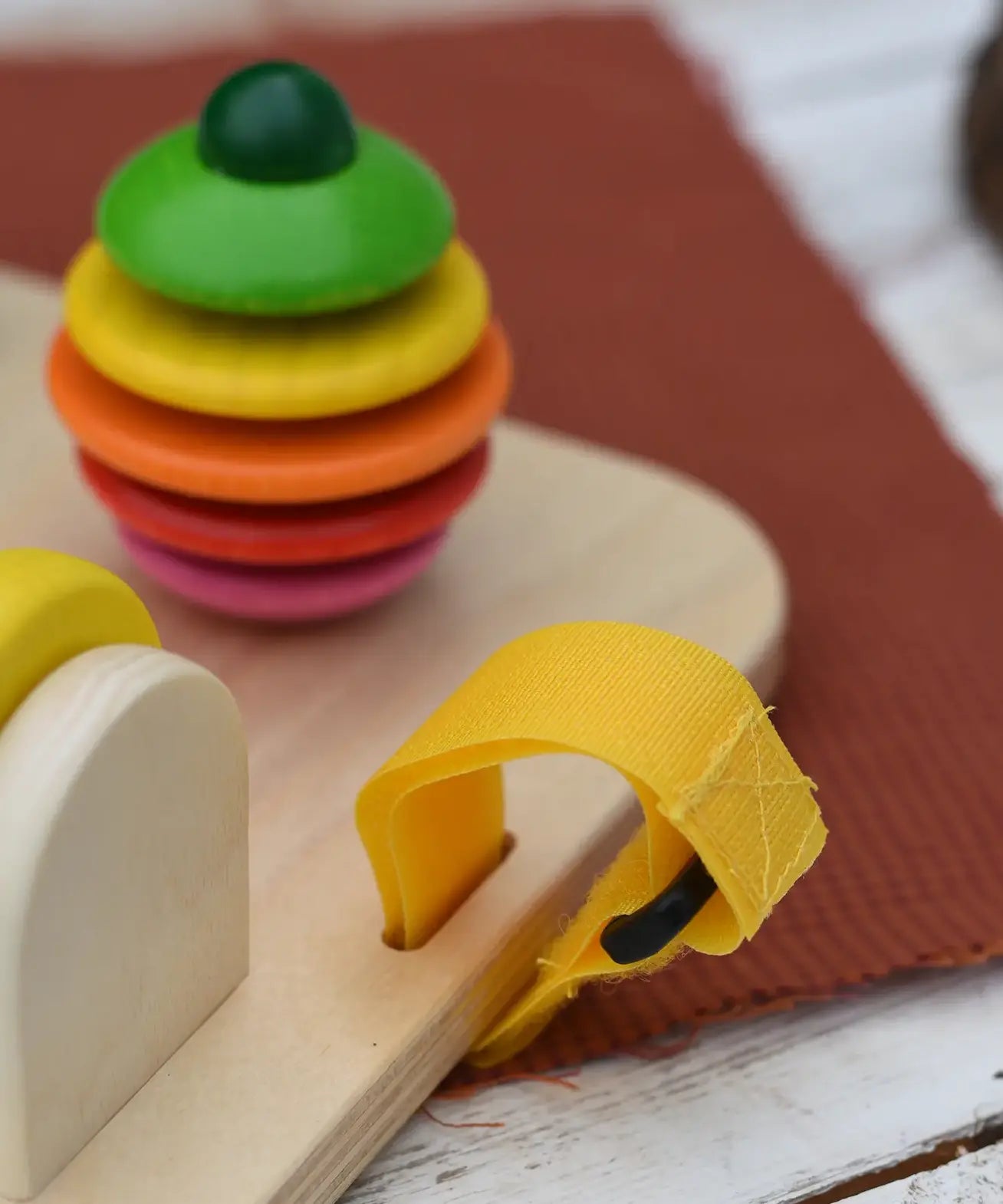 Close up of the velcro straps in the sides on the Nic baby game busy board toy.