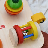 Close up of the rattling tree top and roller attached to the Nic Wooden Baby Game busy Board with 4 four activities.