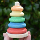 Nic Classic Stacking Tower wooden baby toy in an adult's hand.
