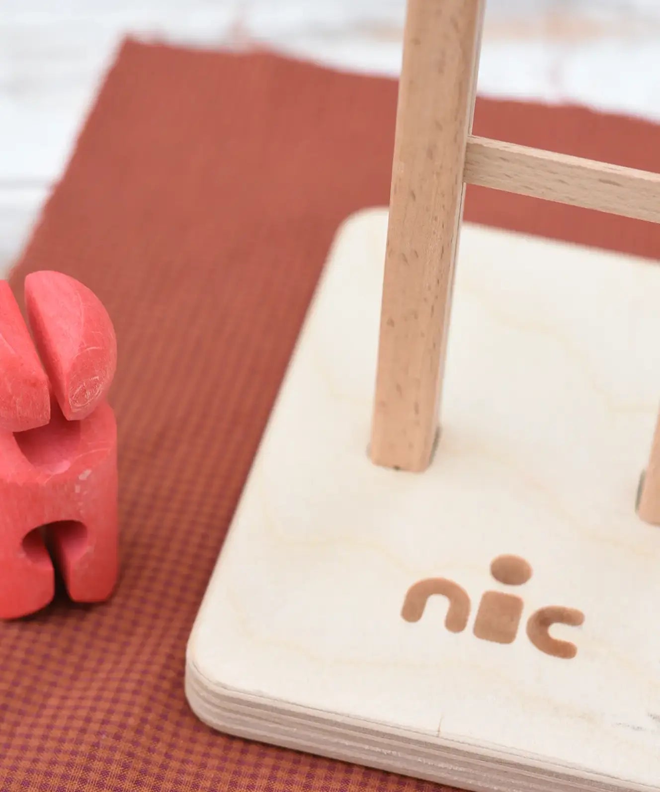 Close up of the Nic logo on the ladder of the Nic climbing wooden ladder toy.