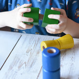 Child screwing two green wooden blocks together from the Nic screws and nuts colorful wooden toy threaded blocks and shapes set.