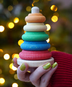 Baby wooden ring stacking toy by Nic Toys, Plug Column, natural wooden bade with chunky colourful rings, available to buy at Babipur.
