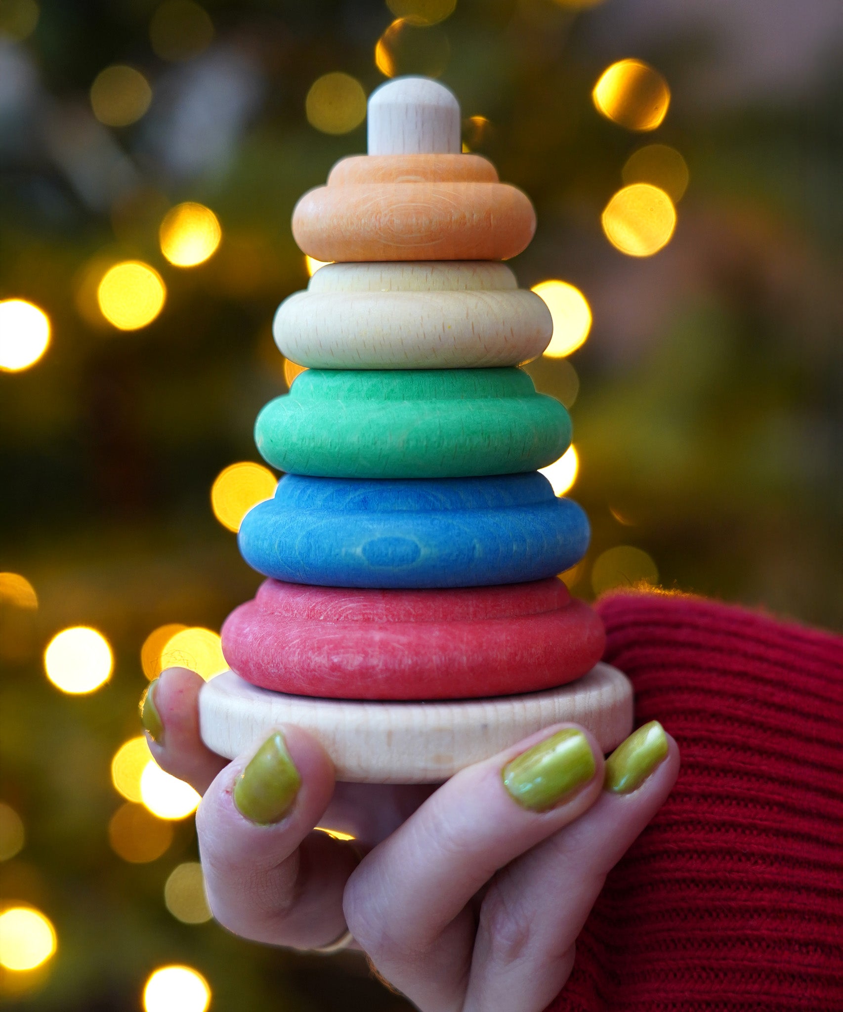 Baby wooden ring stacking toy by Nic Toys, Plug Column, natural wooden bade with chunky colourful rings, available to buy at Babipur.
