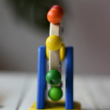 Side view of the Nic Toys ferris wheel colorful wooden toy for infants and toddlers. 