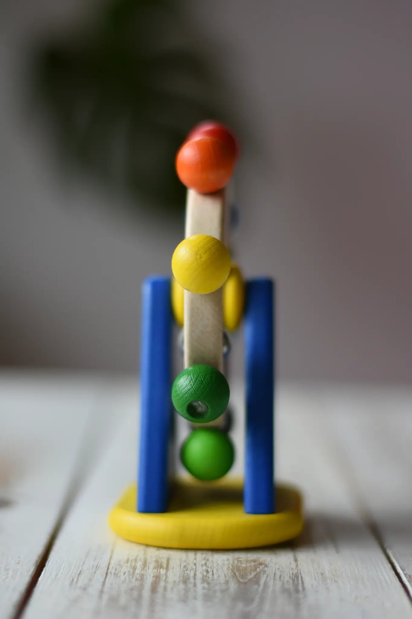 Side view of the Nic Toys ferris wheel colorful wooden toy for infants and toddlers. 