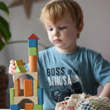 Child stacking the blocks from the Glückskäfer Wooden Bio Geometric Building Blocks, 58 Piece Set. 