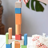 Child stacking the blocks from the Glückskäfer Wooden Bio Geometric Building Blocks. 58 Piece Set.