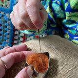 Child using Nic felting needle with Gluckskafer felt in a heart shape.