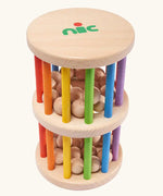 Nic Toys Rattle n Roll - a natural wooden baby toy with rainbow stained rungs and wooden marbles that rattle as the wheel rolls.