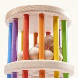 Nic Toys Rattle n Roll - a wooden rolling wheel toy featuring rainbow stained rungs and natural wooden marbles.