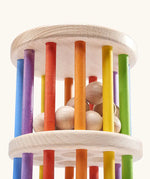 Nic Toys Rattle n Roll - a wooden rolling wheel toy featuring rainbow stained rungs and natural wooden marbles.