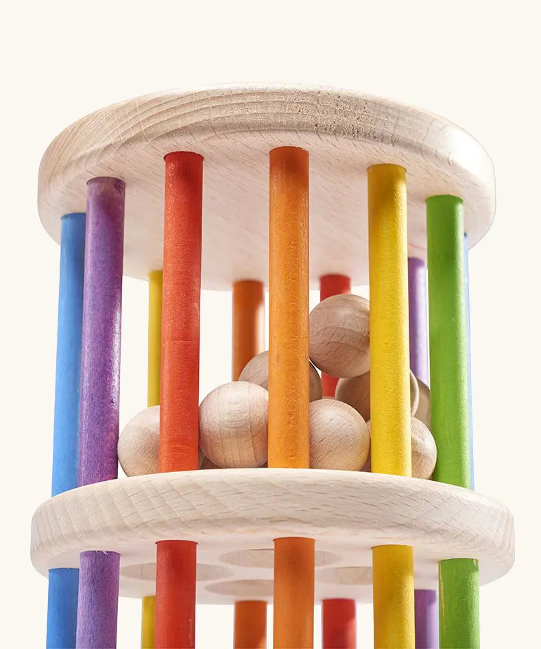 Nic Toys Rattle n Roll - a wooden rolling wheel toy featuring rainbow stained rungs and natural wooden marbles.