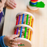 Nic Toys Rattle n Roll - a wooden rolling musical toy with a natural finish, colourful rainbow rungs and wooden marbles inside.