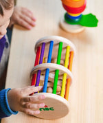 Nic Toys Rattle n Roll - a wooden rolling musical toy with a natural finish, colourful rainbow rungs and wooden marbles inside.