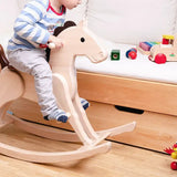 Nic Toys rocking horse, heirloom quality made from wood with a natural finish and brown mane and tail in playroom setting.