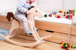 Nic Toys rocking horse, heirloom quality made from wood with a natural finish and brown mane and tail in playroom setting.