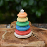 Nic wooden Classic Stacking Tower baby toy placed on a wooden board.