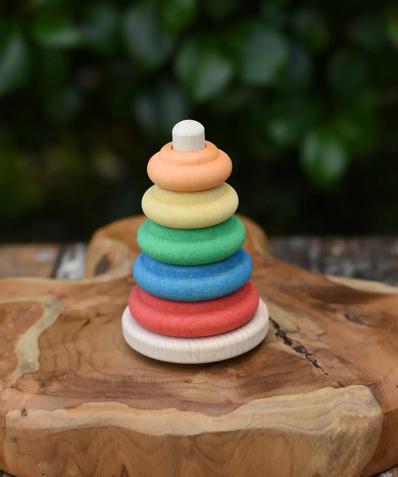 Nic wooden Classic Stacking Tower baby toy placed on a wooden board.