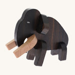 The Bajo Puzzle & Sorter - Black Oak Mammoth which has been made. The mammoth has light coloured wooden tusks and a dark wooden body. On a cream background