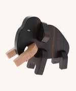 The Bajo Puzzle & Sorter - Black Oak Mammoth which has been made. The mammoth has light coloured wooden tusks and a dark wooden body. On a cream background
