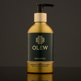 Olew Clarifying Shampoo, vegan haircare which is SLS and Paraben Free, in a gold and dark green bottle with a push down pump on top. The image is on a dark grey background