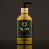 Olew Curl Defining Natural Hold Gel, vegan haircare which is SLS and Paraben Free in a gold and dark green bottle with a push down pump top, on a dark grey background